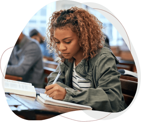 Young student taking her exam at desk